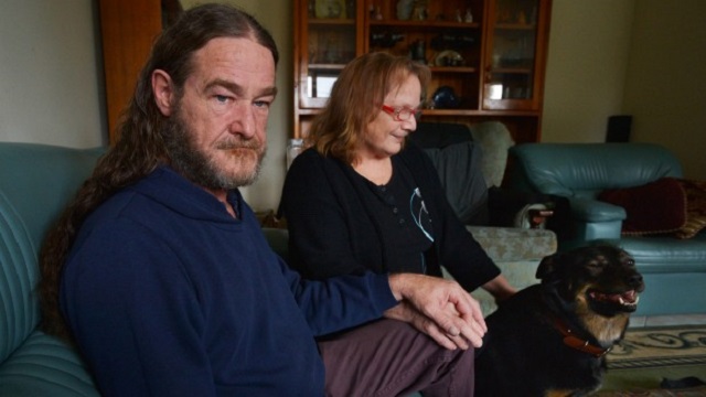 Matthew and Elizabeth Pallett at home with their dog Champ. Photo: Joe Armao 
